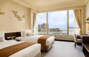A bed or beds in a room at Hong Kong Gold Coast Hotel