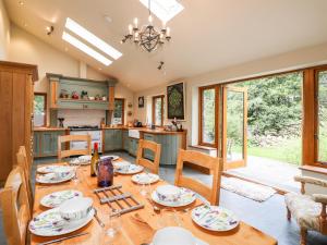a dining room and kitchen with a table and chairs at Eagle Farmhouse in Glenridding