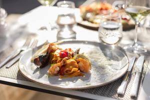 a plate of food with shrimp on a table at Hotel Osam - Adults Only in Supetar