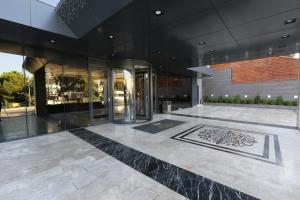 a lobby of a building with a glass door at Royal Termal Hotel in Bursa