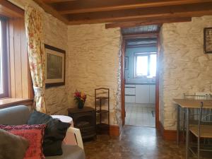 a living room with a couch and a table at Welshhomestead in Tregaron