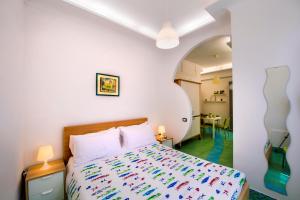 1 dormitorio con 1 cama con colcha colorida en Casa Evelina, en Sant'Agnello