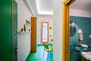 een badkamer met een wastafel, een tafel en een stoel bij Casa Evelina in Sant'Agnello