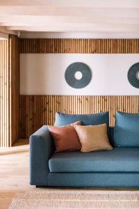 a blue couch in a living room with pillows at Apartaments Cap Sa Sal in Begur