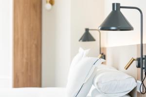 Postel nebo postele na pokoji v ubytování Hotel LIVVO Lumm