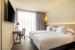 Postel nebo postele na pokoji v ubytování Hotel LIVVO Lumm