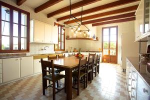 a large kitchen with a wooden table and chairs at Property Son Marina in Palma de Mallorca