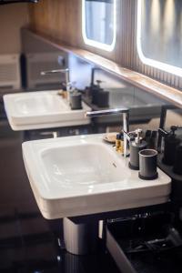 ベグールにあるApartaments Cap Sa Salのバスルーム(白い洗面台、鏡2つ付)