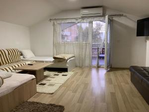 a living room with a couch and a table at Venecia Plaza Struga in Struga