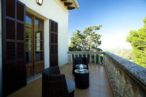 a balcony with chairs and a table on a wall at Property Son Marina in Palma de Mallorca