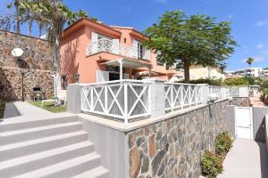 a house with a white fence and stairs at Chalet Santa Ana 7 by VillaGranCanaria in Playa del Ingles