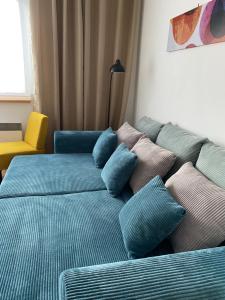 a bed with blue pillows in a room at Apartment Dony in Donovaly