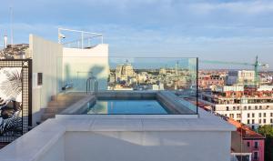 a swimming pool on the roof of a building at Pestana CR7 Gran Vía Madrid in Madrid