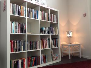 a book shelf filled with books next to a table at Sentrumsgården Motell AS in Presteid