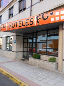 a building with a sign for a hotel at Apartahotel FC Catedral in León