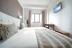 A bed or beds in a room at Hotel Matilde by Grupo Matilde