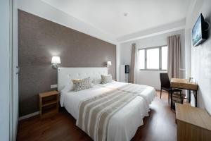 A bed or beds in a room at Hotel Matilde by Grupo Matilde