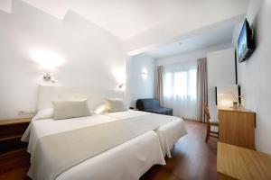 A bed or beds in a room at Hotel Matilde by Grupo Matilde
