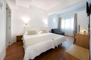 A bed or beds in a room at Hotel Matilde by Grupo Matilde