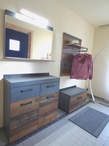 a room with a dresser and a mirror and a drawer at Ferienwohnung Högel Großjena in Naumburg +27 photos
