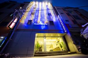 a building with christmas lights on the side of it at Hotel Plaza Heights in Bangalore