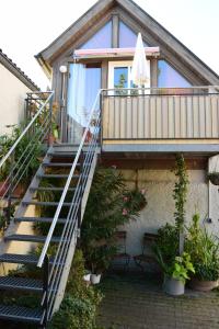 eine Treppe, die zu einem Haus mit Topfpflanzen führt in der Unterkunft Apartments Bed & Breakfast Brückner in Willanzheim