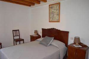 a bedroom with a bed and two tables and a chair at Casa de Diego y Mela in San Bartolomé de Tirajana +71 photos