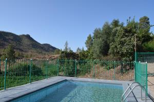 a swimming pool with a fence around it at Casa de Diego y Mela in San Bartolomé de Tirajana