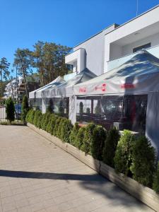 a catering tent in front of a building at Apartment LILY - Baltic Park Pogorzelica in Pogorzelica