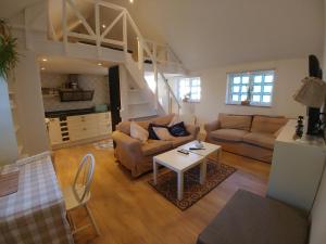 a living room with a couch and a table at Rosdala gård - gästhuset in Rydsgård