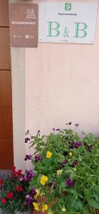 a sign and flowers in front of a building at La Tegola in Como