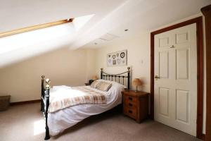 a bedroom with a bed and a skylight at 1 Friary Cottages, Appleby-in-Westmorland in Appleby