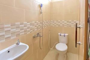 a bathroom with a shower and a toilet and a sink at RedDoorz Plus at Permata Gueshouse Lampung in Lampung