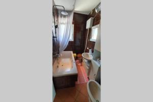 a bathroom with a sink and two toilets at Apartman Robert *** in Duga Resa