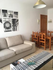 a living room with a couch and a table at Paris Lovely in Gran Tarajal