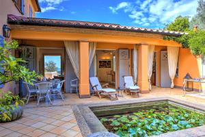 a patio with a pool and a table and chairs at Villa Le Cave 12, Emma Villas in La Caduta