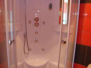 a shower in a bathroom with a glass door at Apartments Špiko in Hvar