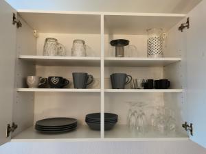 a white cabinet with plates and vases on it at Studio Langstross, Petite France, Hypercentre, Strasbourg in Strasbourg