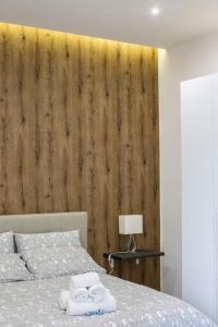 ein Schlafzimmer mit einer Holzwand neben einem Bett in der Unterkunft Mamì B&B in Neapel