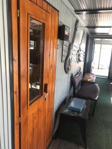 a train room with a door and a bench and a table at Tisza beach Wild Camping 2 in Szeged