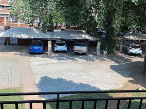 a group of cars parked in a parking lot at Beesdam Guesthouse in Potchefstroom