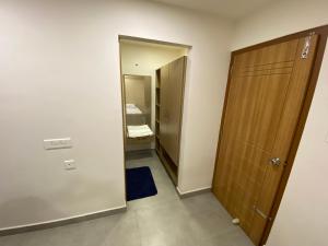 a small room with a door and a mirror at KARIPPALS INN in Kottayam