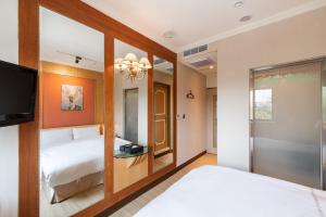 a hotel room with two beds and a tv at 二川行旅 - HiRiver Hotel in Taichung +23 photos