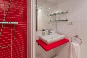 a bathroom with a white sink and red tiles at Nautilus Atico, 3 dormitorios, puerto, by Bookindenia in Denia +32 photos