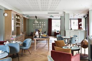 a restaurant with tables and chairs in a room at Hôtel Botaniste in Paris