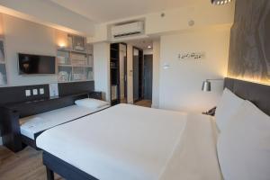 Ein Bett oder Betten in einem Zimmer der Unterkunft ibis Styles Taubate