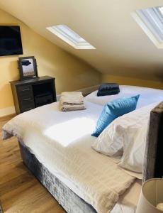 a bedroom with two beds and a tv on the wall at Marine Boathouse View Apartment in Skegness