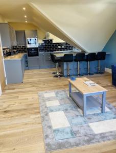 a living room with a table and a kitchen at Marine Boathouse View Apartment in Skegness +21 photos