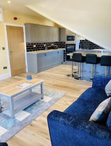 a living room with a couch and a table at Marine Boathouse View Apartment in Skegness