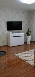 a living room with a flat screen tv on a wall at Studio Apartment in the center in Shostka